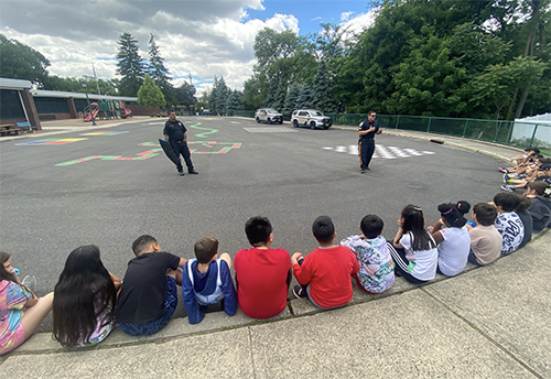 Students sitting and listening to K-9 unit presentation