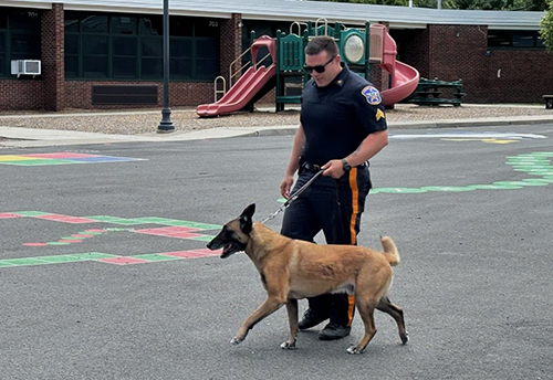 Police officer walking dog