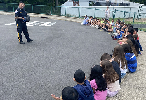 Police officer talking to students