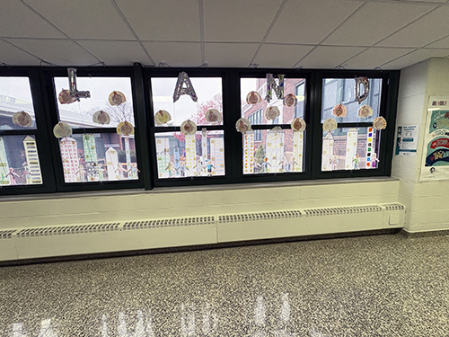 Student projects displayed on the school windows celebrating Thanksgiving