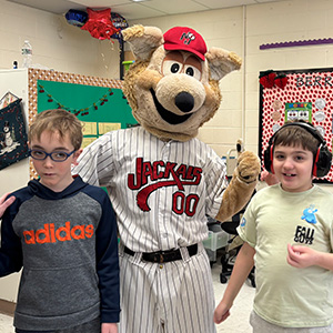 Two students standing next to Jack the Jackal