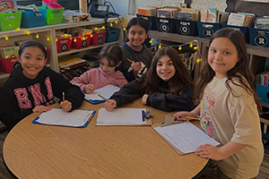 Students writing on clipboards