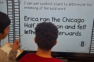 Two students reading a clue