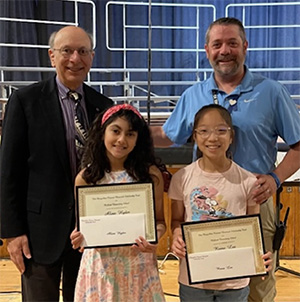 Two students with awards and two staff members